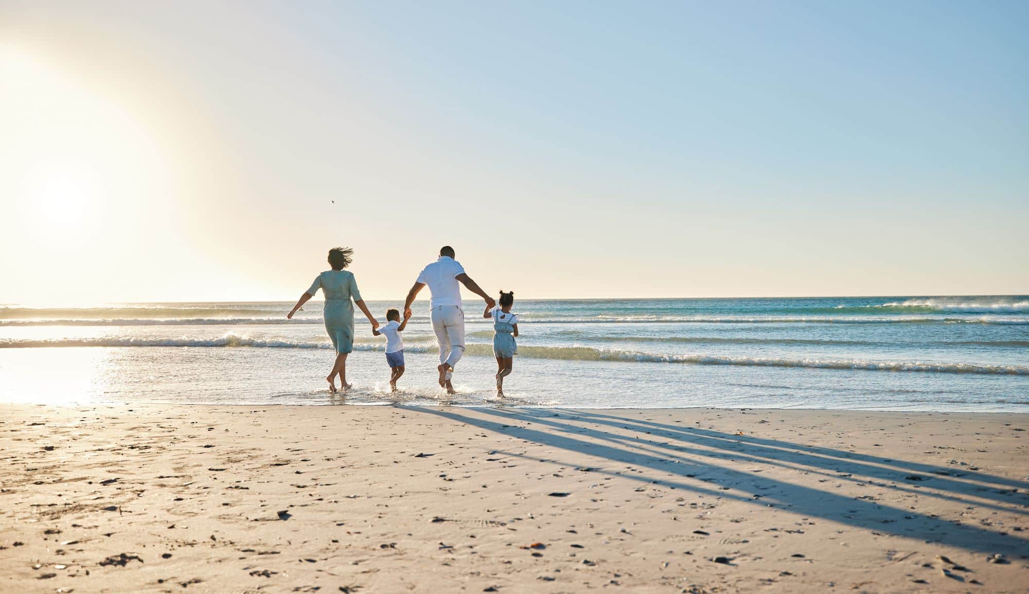 family of four on the beach near The Alary aparments for rent fort myers istock 1397843969